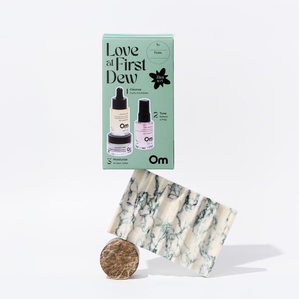 OM Organics Love At First Dew skincare set with mini cleanser, hydrating face mist, and moisturizer arranged together for a complete three-step routine.