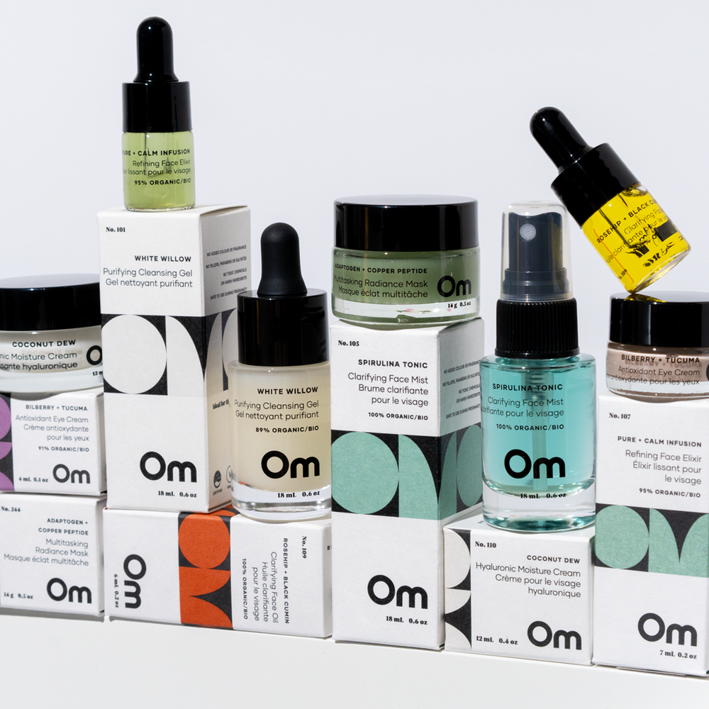 Collection of skincare products on a stone block with 'Om' branding. These are from OM ORGANICS Mini Face Care Kit for Combination Sensitive / Blemish Prone