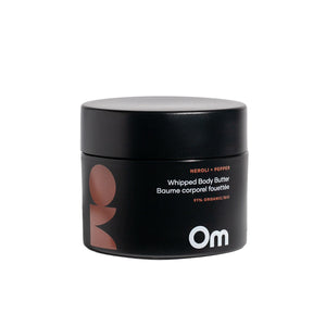 Om Organics Neroli + Pepper Whipped Body Butter in a glass jar, a rich and nourishing cream for soft, hydrated skin.