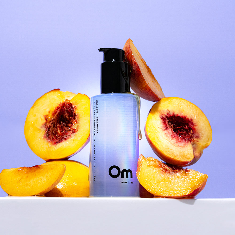 Om Organics Peach Seed + Capsicum Euphoria Lubricant Oil, a nourishing, 100% organic lubricant with peach seed oil and capsicum extract for a smooth, velvety feel and subtle warming sensation. Unscented and paraben-free.