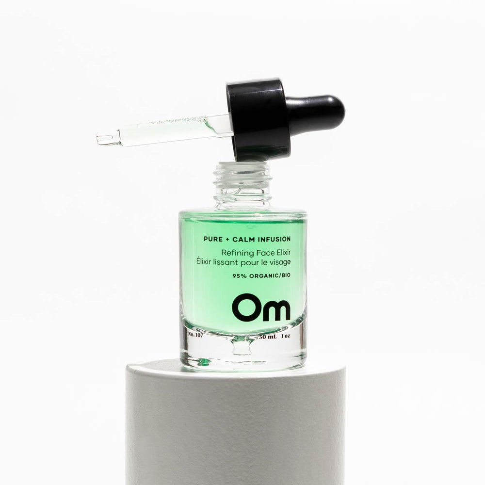 OM ORGANICS Pure + Calm Infusion Refining Face Elixir, 30 ml bottle; hydrates, brightens, and balances skin with botanical extracts like skullcap and licorice root; ideal for oily, sensitive, or combination skin types.
