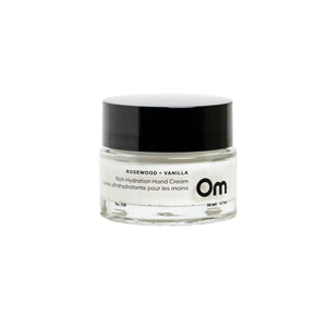 OM ORGANICS Rosewood + Vanilla Rich Hydration Hand Cream in clear glass jar with black lid on white background