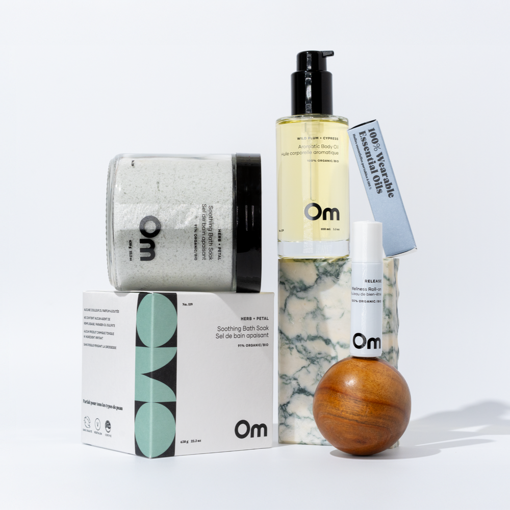 OM Organics Soothe & Renew set with Herb + Petal Bath Soak, Wild Plum + Cypress Body Oil, and Release Wellness Roll-On for a relaxing nighttime skincare ritual.