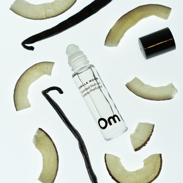 OM ORGANICS Vanilla Moon Scented Roll On surrounded with coconut slices and vanilla