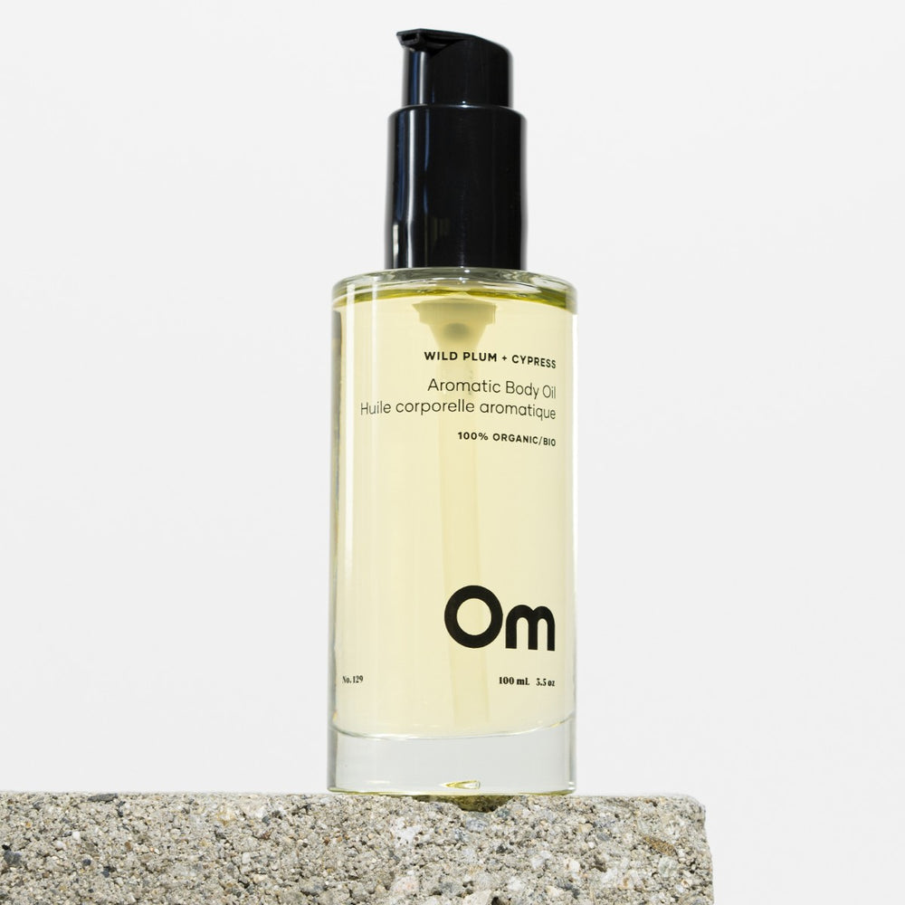 Om Organics Wild Plum + Cypress Aromatic Body Oil, a hydrating, nourishing oil for silky soft, glowing skin. Features sweet plum and woodsy cypress for a luxurious, all-over glow.