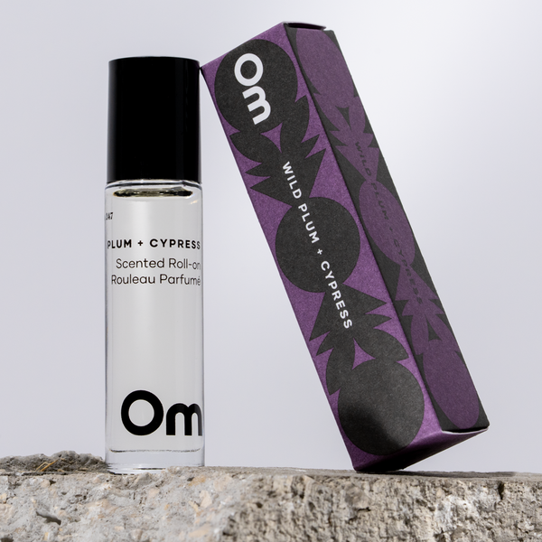 OM Organics Wild Plum and Cypress scented roll-on perfume made with organic plant-based oils and essential oils in a glass roll-on bottle.