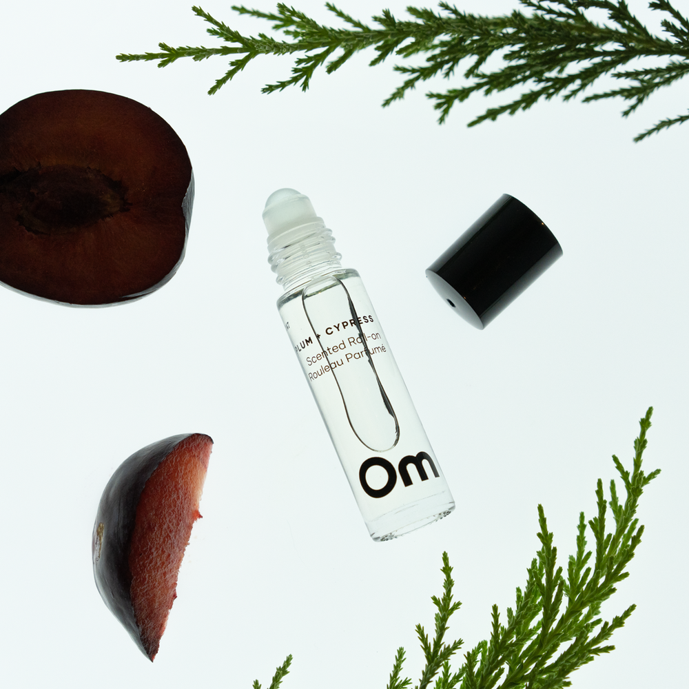 OM Organics Wild Plum and Cypress scented roll-on perfume made with organic plant-based oils and essential oils in a glass roll-on bottle.