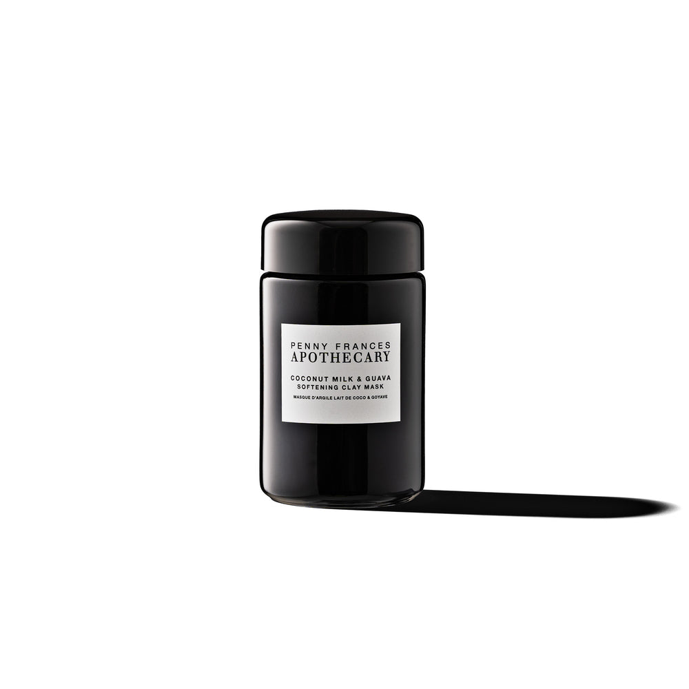 Glass jar of Penny Frances Apothecary Coconut Milk & Guava Softening Clay Mask with tropical fruit extracts, coconut milk, and rhassoul clay.