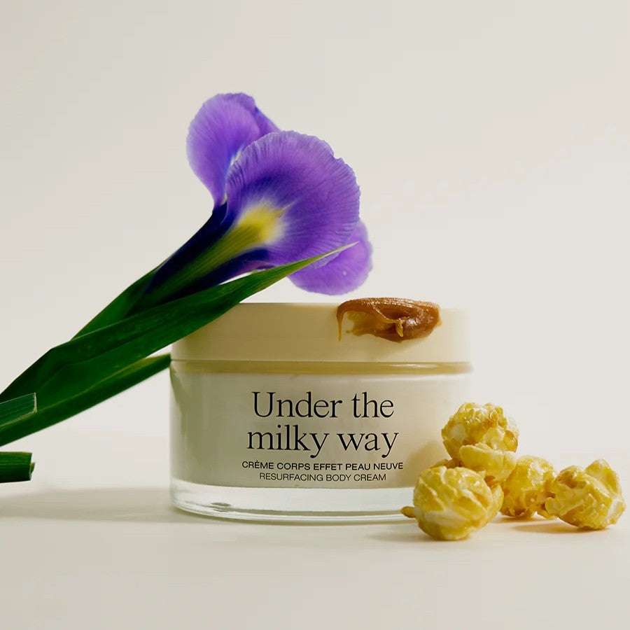 Refeel Naturals Under the Milky Way Skin-Renewing Body Cream in minimalist packaging, described as smoothing, hydrating, and delicately scented with iris, popcorn, and salted caramel.