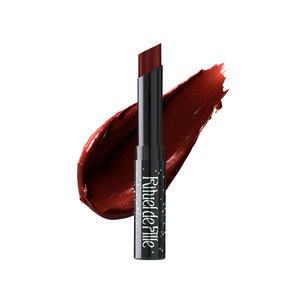 Rituel de Fille Enchanted Lip Sheer in Adder’s Tongue, a sheer bitten-blood red lipstick in a sleek black star-dusted tube with a semi-matte finish.