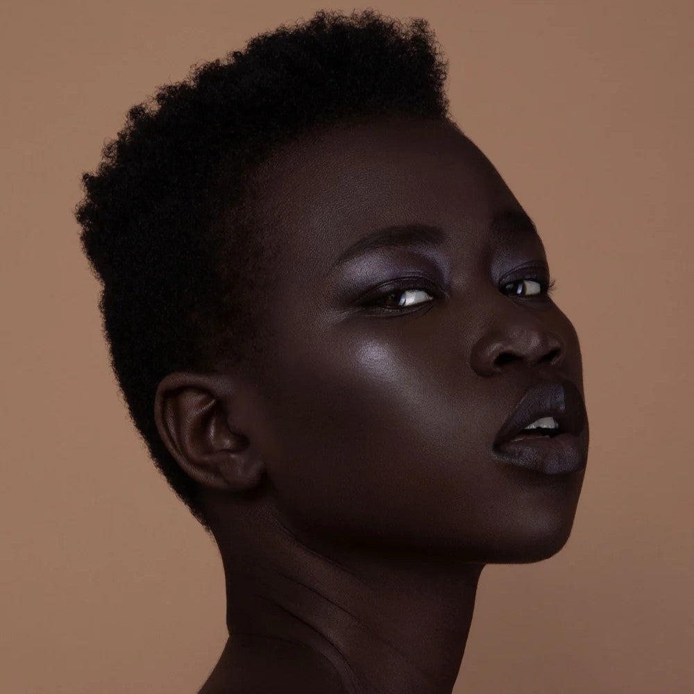 RITUEL DE FILLE Inner Glow Crème Pigment in Eclipse, a deep aubergine cream pigment in a starry black compact.