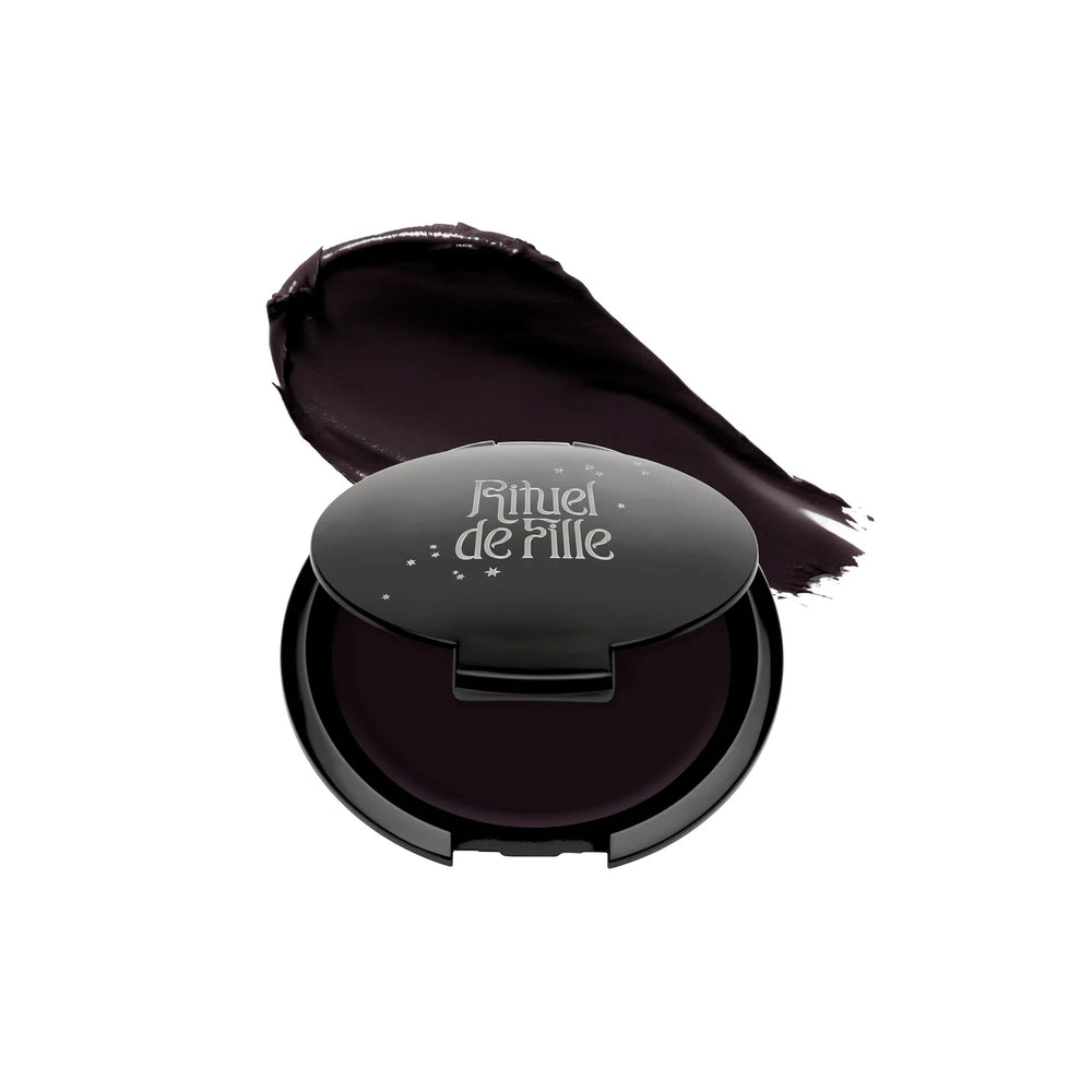 RITUEL DE FILLE Inner Glow Crème Pigment in Eclipse, a deep aubergine cream pigment in a starry black compact.