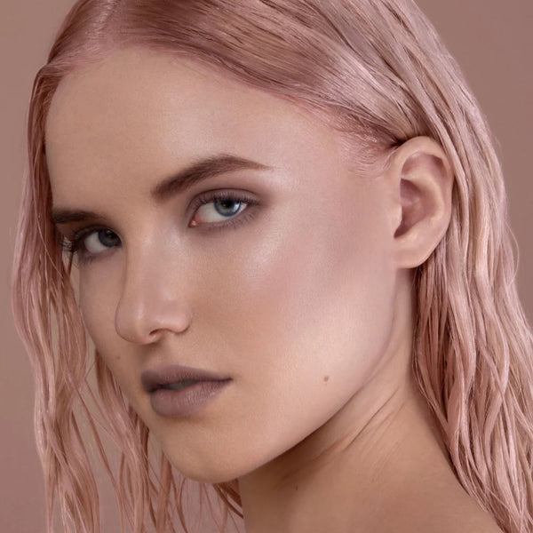 Close-up of a person with pink hair against a light brown background. RITUEL DE FILLE Inner Glow Crème Pigment Intuition