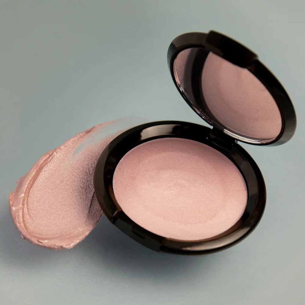 RITUEL DE FILLE Rare Light Crème Luminizer Aurora, a mauve-pink cream highlighter with a soft, iridescent glow in a sleek compact.