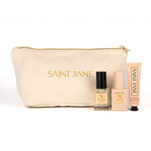 SAINT JANE Holiday Mini Set with Star Flower Serum, Hydrating Petal Cream, Rich Rescue Mucin Cream, and a gold makeup bag.