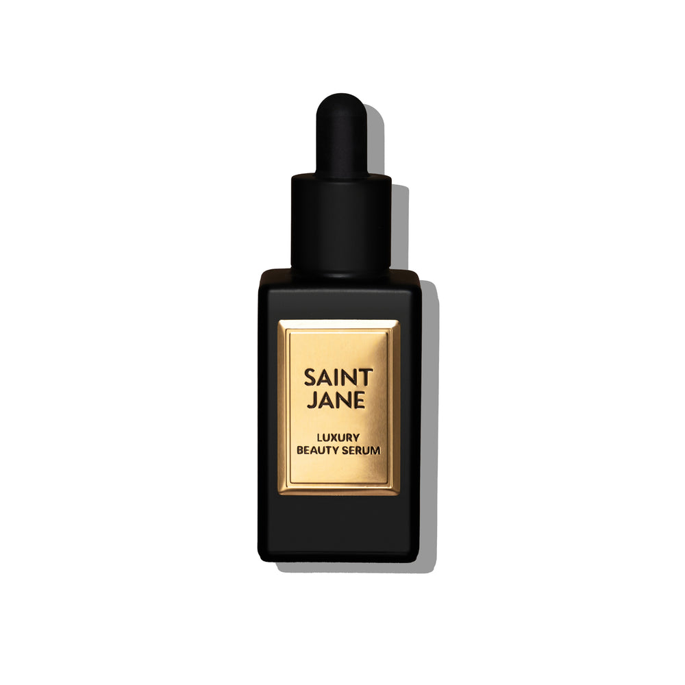 Saint Jane Luxury Beauty Serum in a black rectangular dropper bottle with a gold label, shown on a clean white background with a soft shadow.