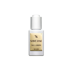 A white glass bottle with white dropper and gold label of SAINT JANE Vitamin C Glow Drops Brightening Serum is on white background
