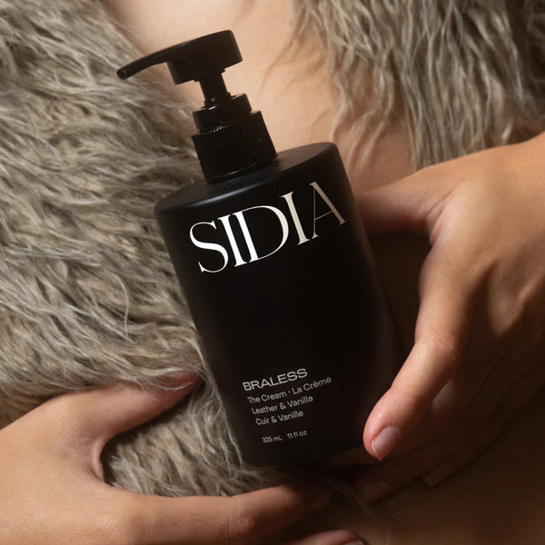 Person holding a black SIDIA body cream