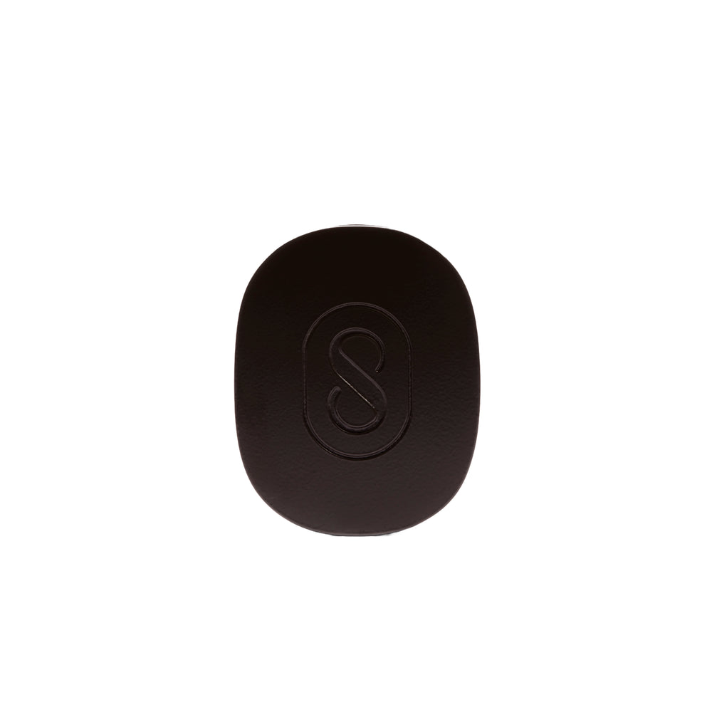 Brown pouch with a black solid perfume inside, featuring the brand 'Sidia' on the pouch, on a white background.