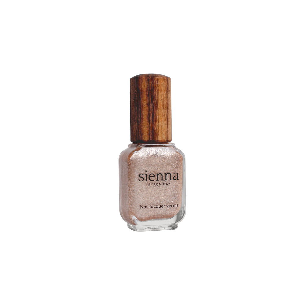  Sienna Byron Bay Believe Nail Polish – shimmery rose-peach shade in eco-friendly packaging.
