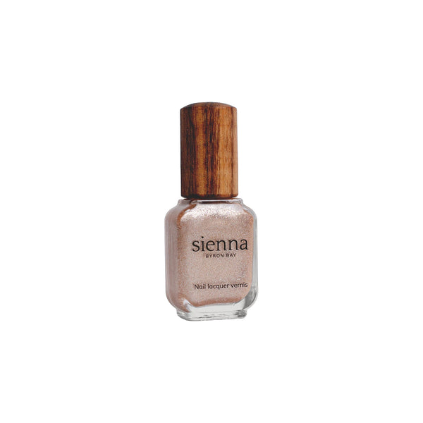  Sienna Byron Bay Believe Nail Polish – shimmery rose-peach shade in eco-friendly packaging.