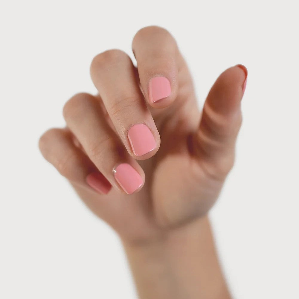 Sienna Byron Bay Glowing Nail Polish in a warm midtone peachy pink crème shade with sustainable packaging.