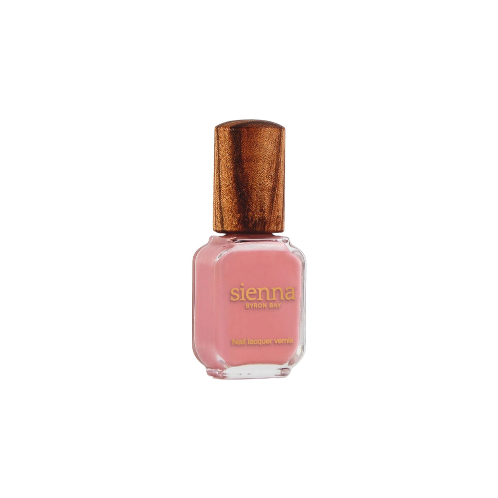 Sienna Byron Bay Glowing Nail Polish in a warm midtone peachy pink crème shade with sustainable packaging.