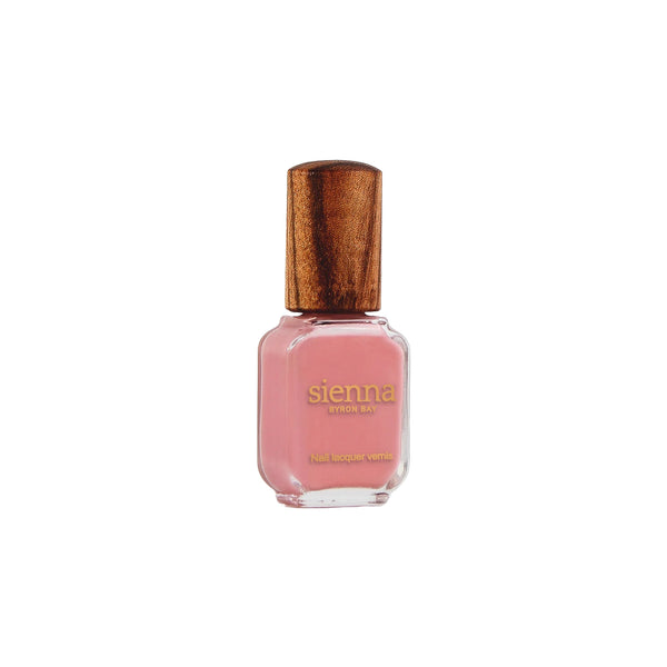 Sienna Byron Bay Glowing Nail Polish in a warm midtone peachy pink crème shade with sustainable packaging.