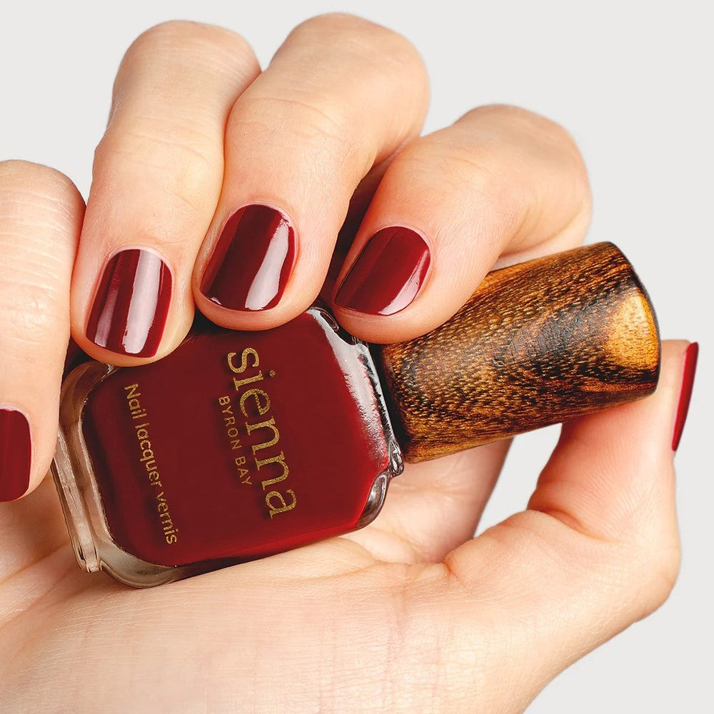 SIENNA BYRON BAY Sacred Nail Polish in Garnet Crème – a deep, organic red with a smooth crème finish.