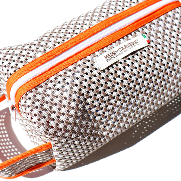 Mesh pouch with orange zipper and 'MADE IN CANADA' label on a white background