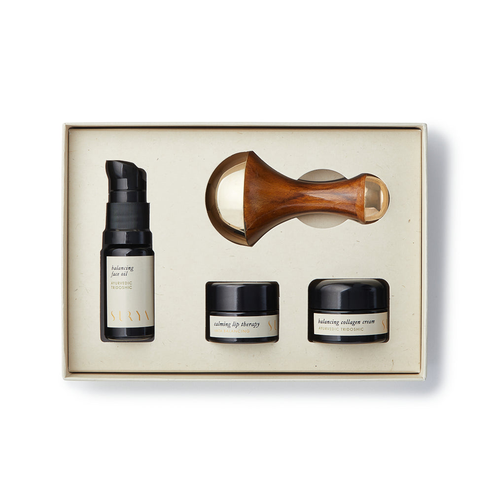 Surya Skincare Discovery Set with Balancing Face Oil, Collagen Cream, Calming Lip Balm, and double-sided Kansa Wand on a white background