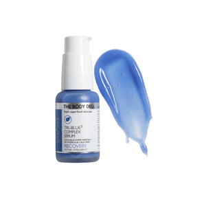 The Body Deli Tri-Blue Complex Serum bottle with a swatch of blue serum on a white background