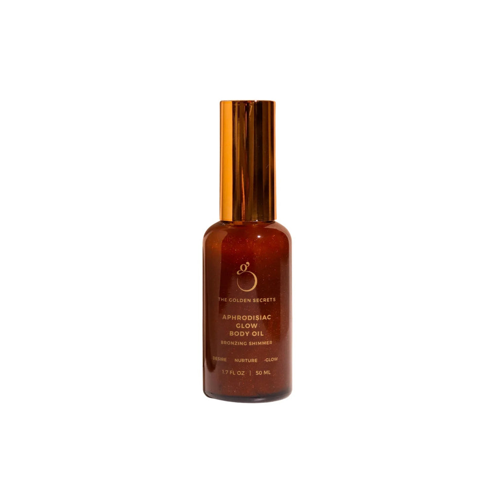 The Golden Secrets Aphrodisiac Glow Oil, a nourishing bronzing body oil that deeply hydrates and enhances your natural glow with a subtle tint. Featuring a blend of jasmine, mandarin, coconut oil, and golden mica, this high vibrational oil nourishes and smooths the skin, leaving a radiant appearance. Perfect for use on the body, face, and hair, it provides a luminous golden glow without DHA or synthetic fragrance. Think Dirty Verified, this versatile oil hydrates and nourishes for a youthful, balanced look.