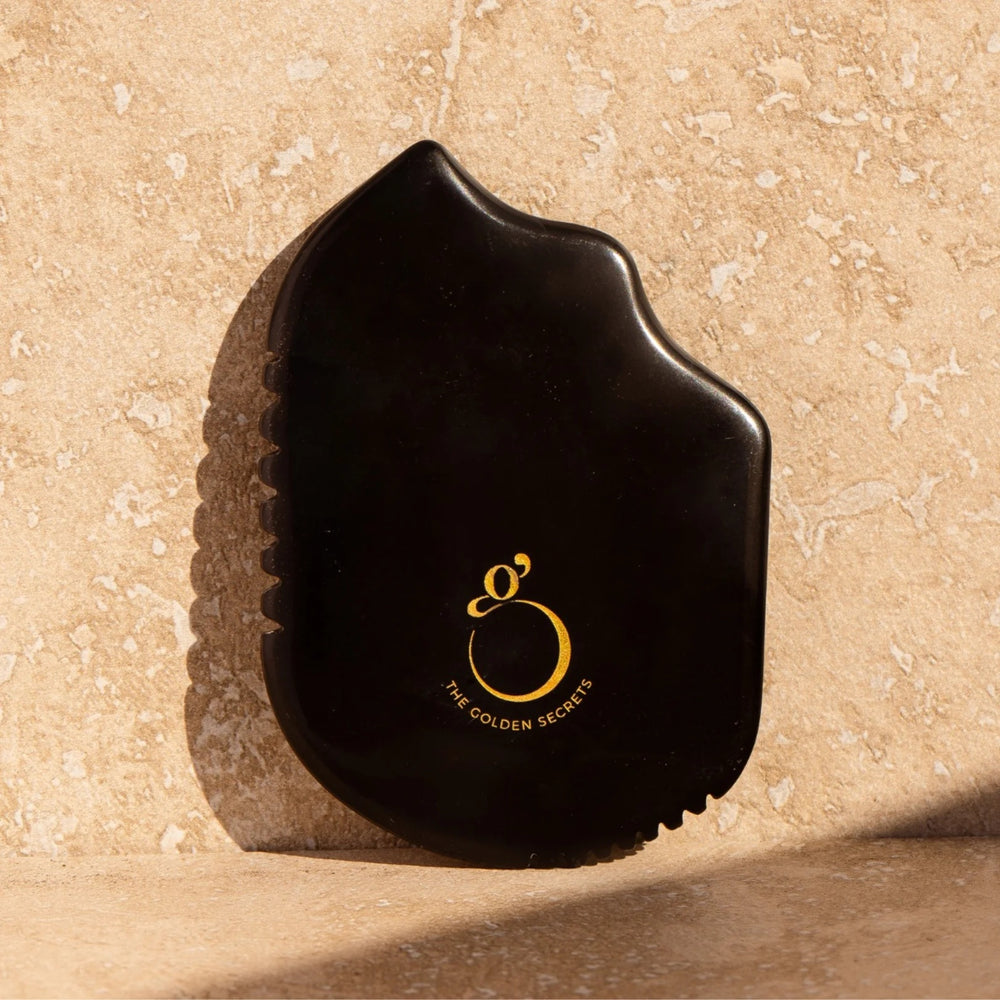 The Golden Secrets Sorceress Stone Gua Sha Beauty Tool, crafted from natural Sibin Bian stone, designed to enhance your skincare routine with over 40 trace elements.