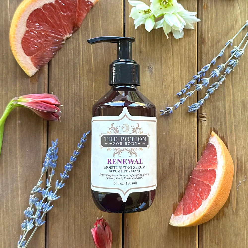 THE POTION COSMETICS Renewal Moisturizing Serum bottle surrounded by flowers and citrus, evoking a blooming garden with fresh, earthy notes.