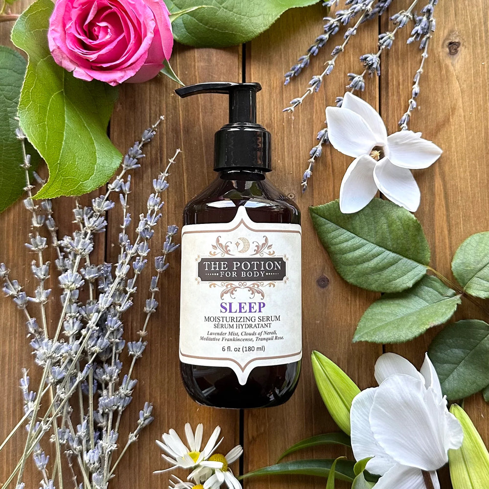 THE POTION COSMETICS Sleep Moisturizing Serum bottle surrounded by lavender, chamomile, and rose petals, evoking a calming nighttime ritual and soothing floral aroma.