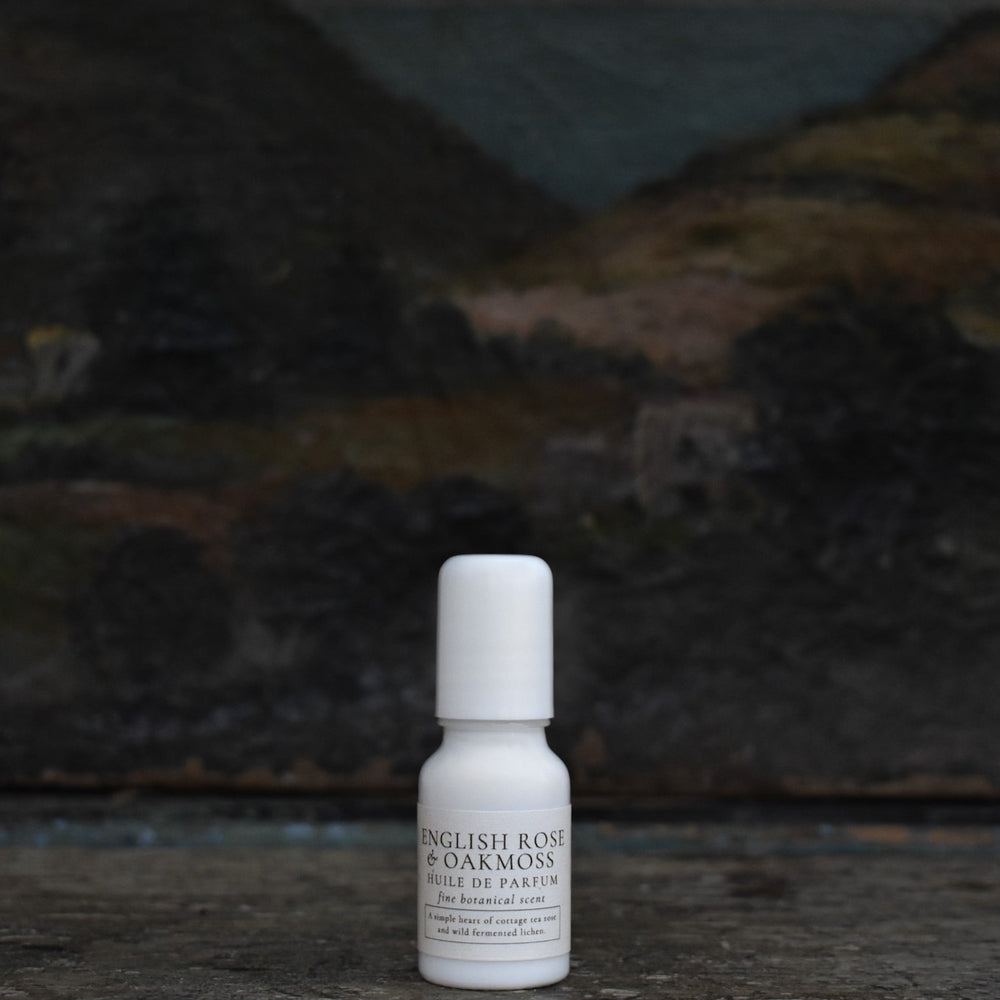 TIDELANDS HOUSE English Tea Rose Huile de Parfum with Fermented Oakmoss in a glass vial with a steel roller, showcasing the elegant and earthy floral fragrance.