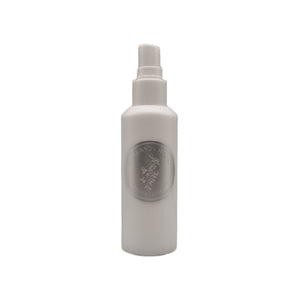 White spray bottle with a logo on a white background. TIDELANDS HOUSE Lilac Nectar Artisanal Copper Distillate