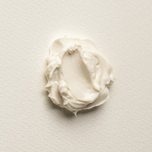 White cream swatch on a light gray background. TRONQUE Firming Butter