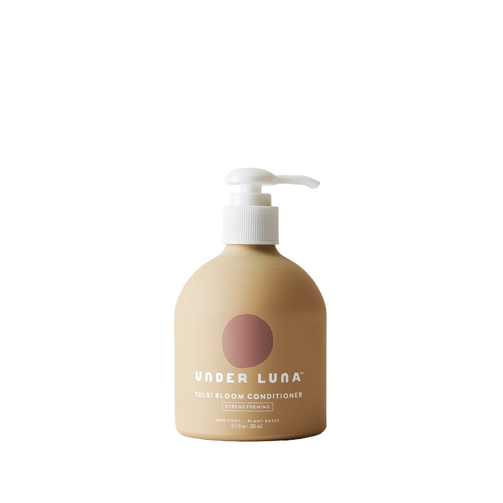 Under Luna Tulsi Bloom Conditioner in recyclable aluminum bottle, enriched with tulsi, nettle, rosemary, and sweet orange for fine to medium hair.