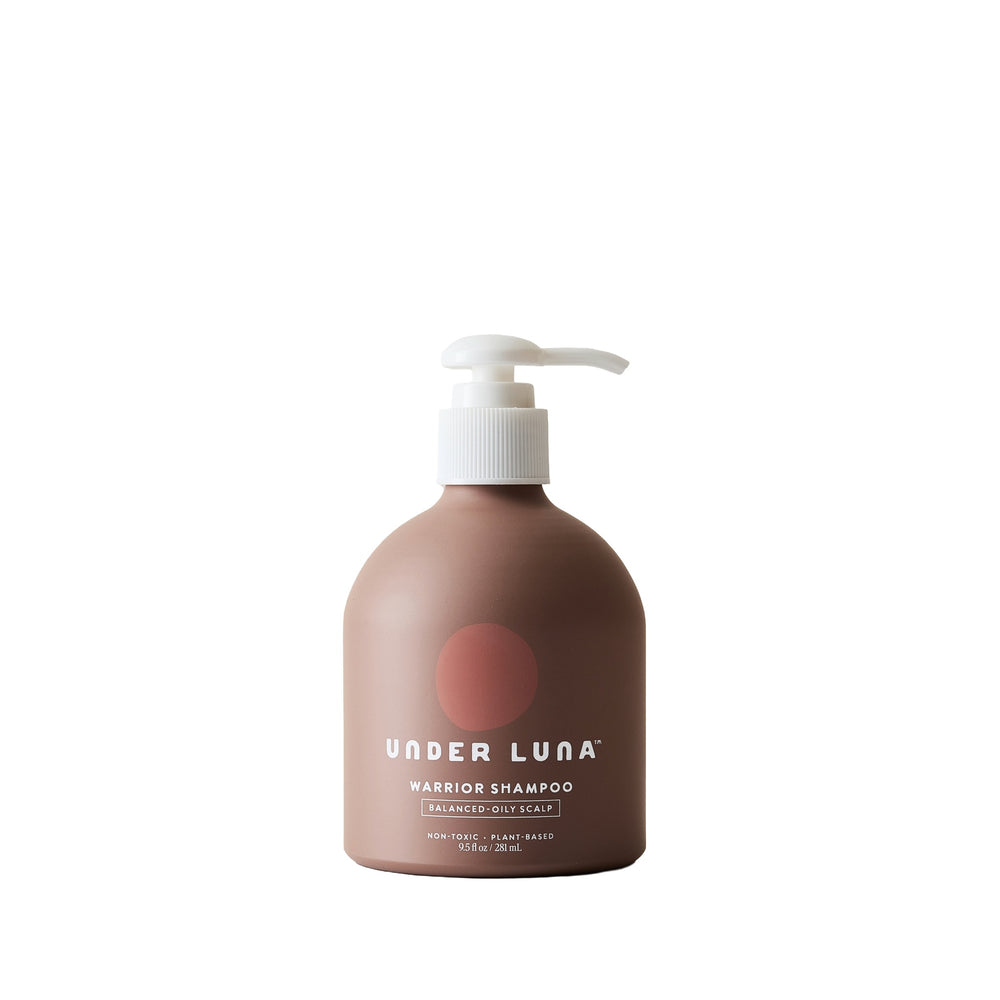 Under Luna Warrior Shampoo in recyclable aluminum bottle with sage and citrus aromatics, designed for oily to balanced scalps.