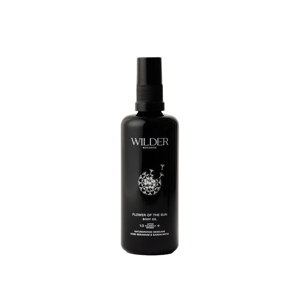 Wilder Botanics Flower of the Sun Body Oil bottle surrounded by natural elements, highlighting its woody and floral ingredients. The oil is presented in eco-friendly packaging, conveying hydration, nourishment, and wellness for all skin types.