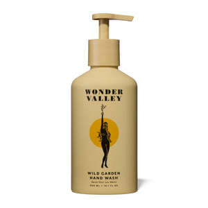 Wonder Valley Wild Garden Hand Wash in a pump bottle with minimalist label, infused with olive oil, carrot seed, and aromatic notes of cedar, basil, mint, rosemary, sage, lavender, and vetiver.