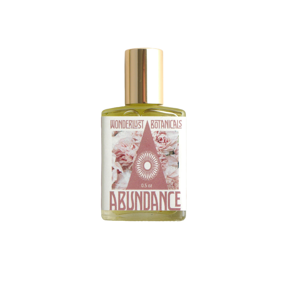 Wonderlust Botanicals Abundance Oil in a 0.5 oz roll-on bottle, featuring a blend of natural essential oils and citrine-infused grapeseed oil.