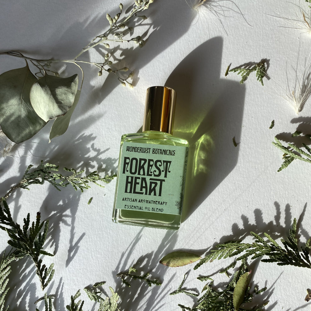 Wonderlust Botanicals Forest Heart perfume oil with a fresh, woodsy and citrus scent, featuring essential oils and infused with Aventurine crystal in grapeseed oil.
