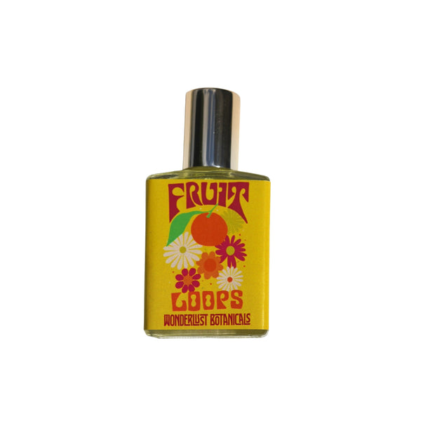 WONDERLUST BOTANICALS Fruit Loops natural roll-on perfume with bright citrus notes of orange, lemon, lime, and lemongrass in a 0.5 oz glass bottle.