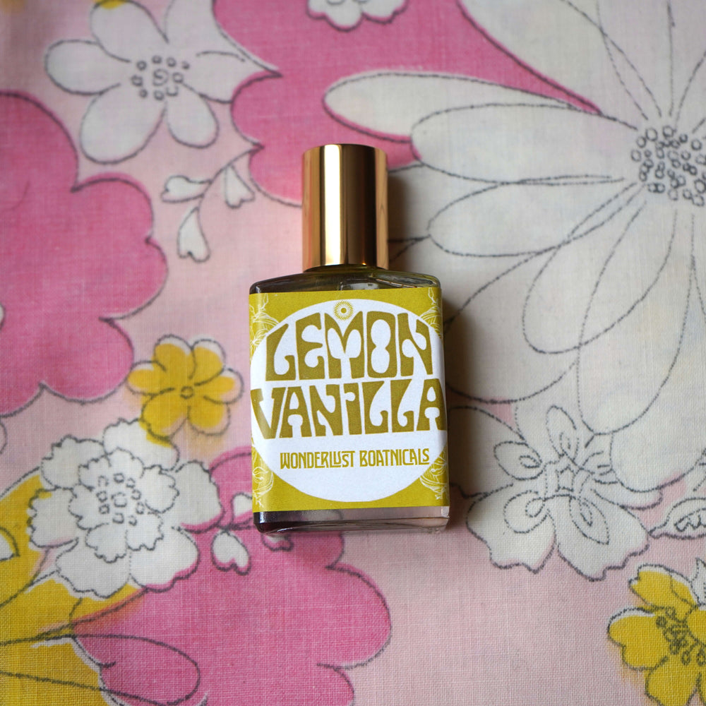 WONDERLUST BOTANICALS Lemon Vanilla natural roll-on perfume in a 0.5 oz glass bottle, featuring a fresh citrus and sweet vanilla blend for an uplifting, summery scent.