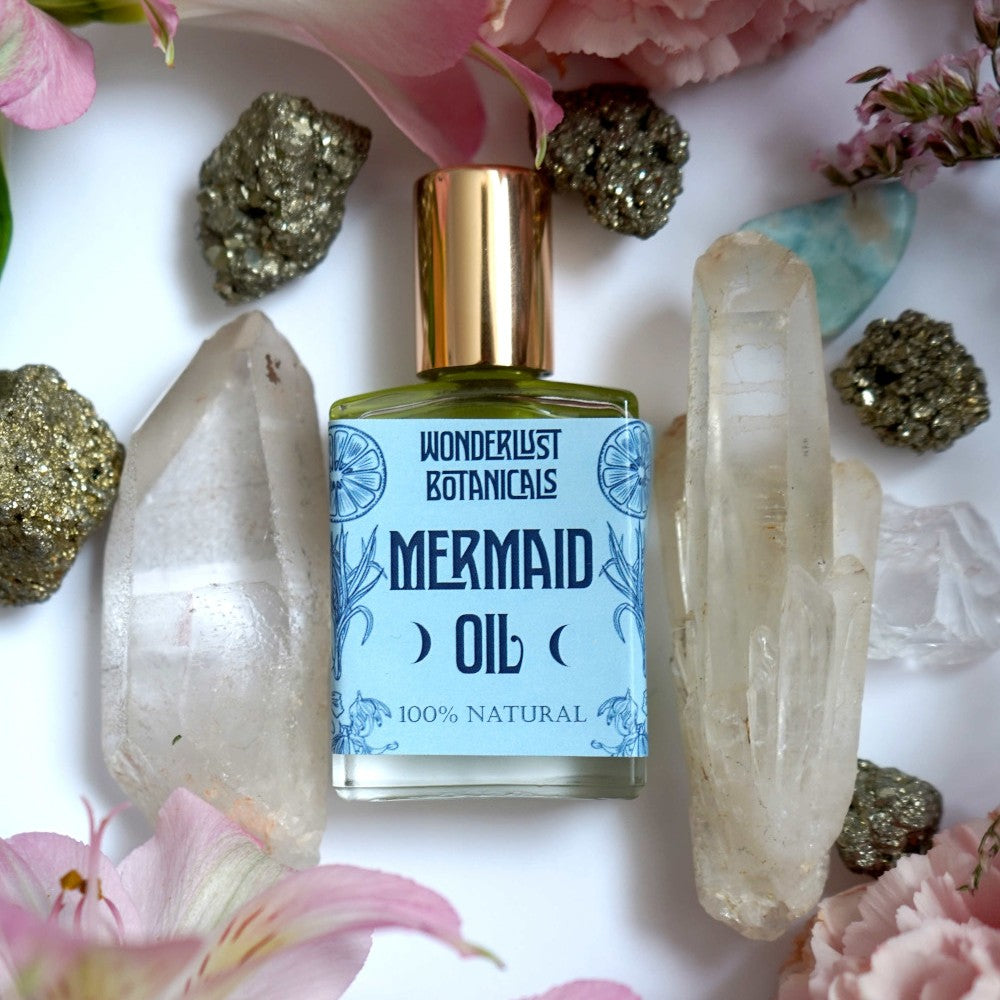 Mermaid Perfume Oil by Wonderlust Botanicals – Tropical fragrance with essential oils of lemongrass, bergamot, and ylang-ylang in a 0.5 oz roll-on bottle.