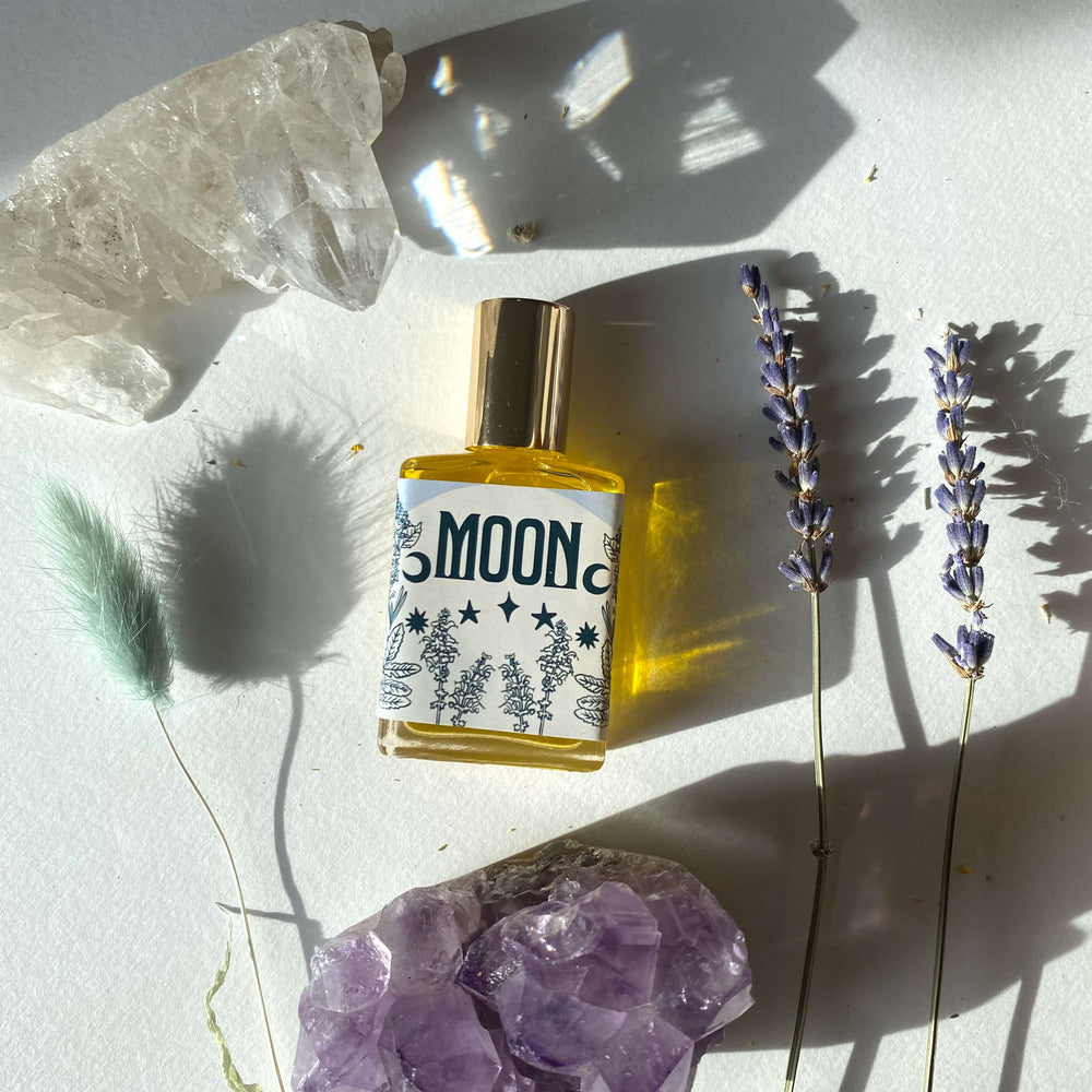 Wonderlust Botanicals Moon Perfume Oil – A calming blend of frankincense, patchouli, lavender, and clary sage essential oils in a 0.5 oz roll-on bottle.