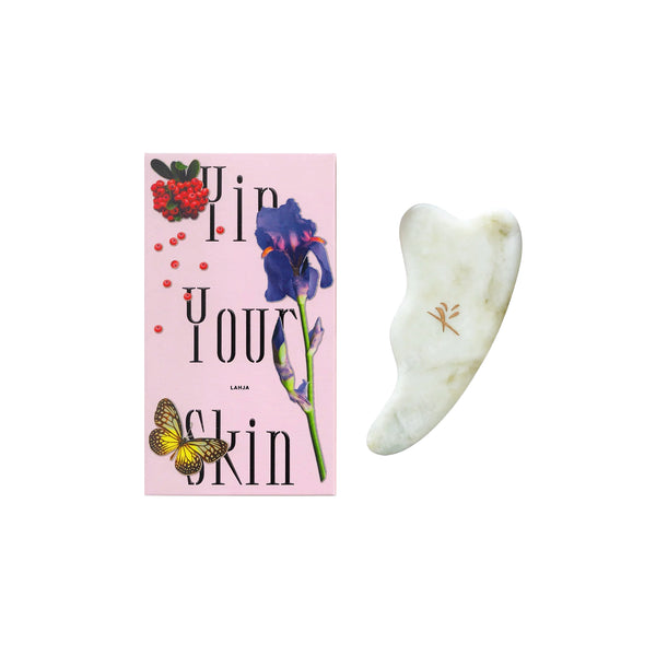 Yin Your Skin LAHJA Gua Sha Facial Tool made of green Xiuyan jade, designed with notches and curves to fit the jawline, cheekbones, and delicate eye area.